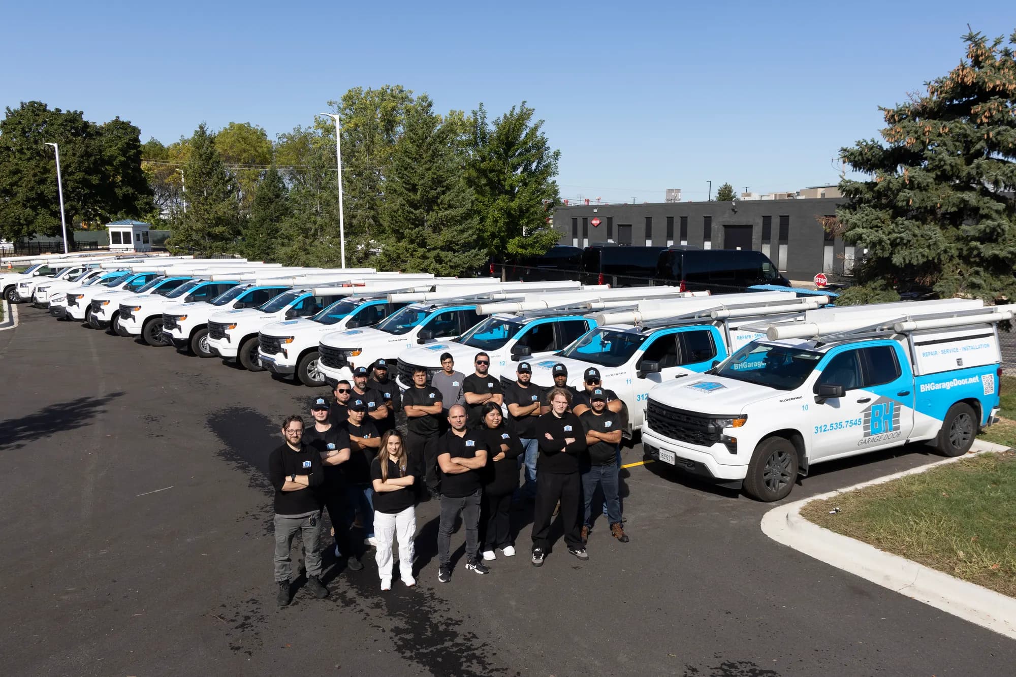 BH Garage Door service fleet lined up outside the shop